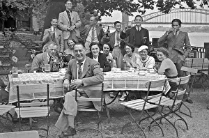 Teacups: People sitting at a table in the open air