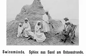 Castles: People in front of a Sphinx sand castle on Usedom, 1905