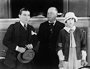 Aging: Three people standing together while one is holding
