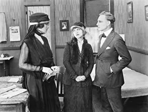 Consoling: Three people standing together in a room talking