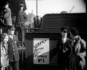 No.1: People Standing by a Sign on a Train Reading: