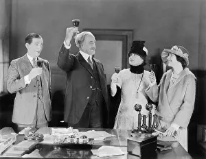 Celebratory: Four people toasting with wine