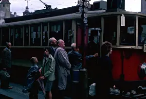 Raincoat: People at a tram stop