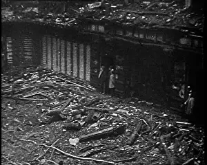 People Walking Around a Burnt Out Building