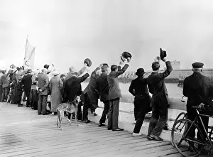 Waterside: People waving their hats at the waterside, WW1