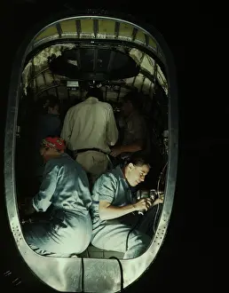 Inspecting: People working inside fuselage of a Liberator Bomber, 1942