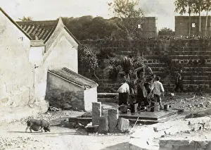 Ramshackle: People working in a back yard, China