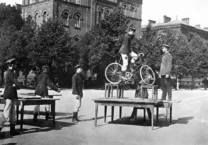 Acrobatics: Performance of cadets on a bike, around 1900