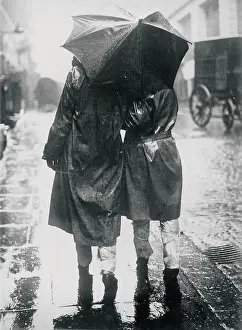 Raincoats: Two persons beneath an umbrella