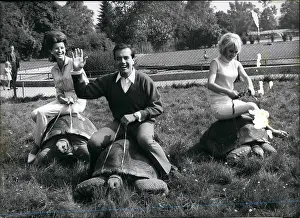 Tortoises: Peter Frohlich riding giant tortoise, Munich Zoo, Germany