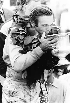 Heirs: Peter Revson drinks from his trophy after winning