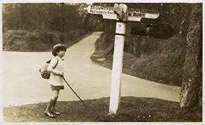 Petworth: Petworth - Young boy checking his directions on a signpost