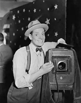 Exaggerated: Photographer with box camera, say cheese