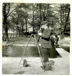 Tripod: Photographer with camera and tripod