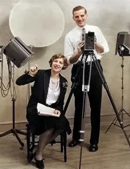 Continuity: Photographer Standing Behind Movie Camera in Studio