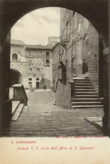 Gimignano: Piazza viewed through archway, San Gimignano, Tuscany, Italy
