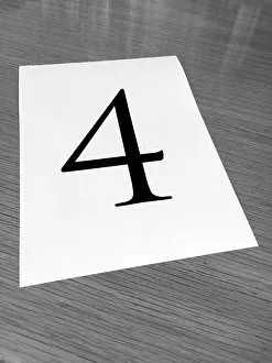 Font: Piece of paper on a desk with a large number 4
