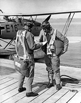 Directions: Pilot and navigator studying a map, 1937
