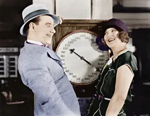 Silliness: Playful couple standing on scale