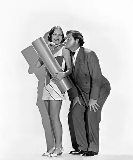 Collaborate: Playful man and woman lighting explosive with cigarette