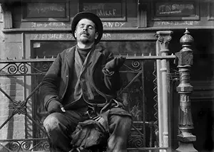 Patched: Pleading beggar holds his hand out on the
