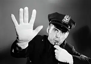 Gloved: Police Man Looking at Camera Hat with Badge Blowing