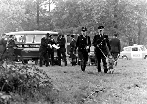 Searching: Police officers with dogs, conducting a search, London