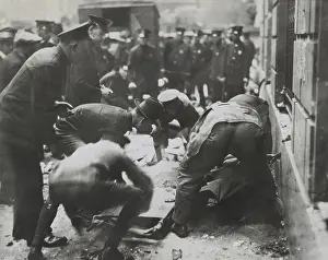 Anarchism: Police removing rubble to reach bodies after the