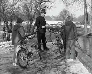 Anorak: Policeman with three boys and their bicycles