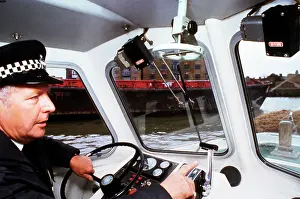 Riverboat: Policeman at the controls of a riverboat