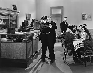 Rarity: Policeman and a man dancing a tango in a restaurant