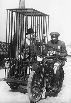 Parking: Policeman on a motorcycle for the prisoner transport, 19