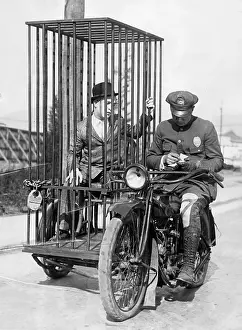 Violated: Policeman on a motorcycle for the prisoner transport