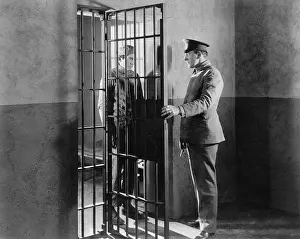 Everett Collection (old Visuals): Policeman and prisoner in a jail cell
