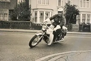 Gauntlets: Policeman riding a Triumph motorcyle
