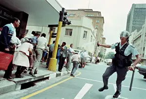 Teargas: Policeman teargases a crowd