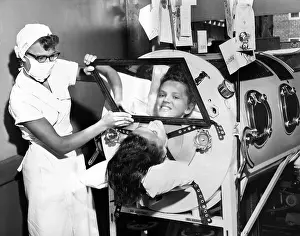 Infantile: Polio patient Flossie Rogers looking at ?
