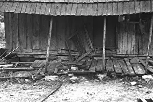 Diets: Porch of a barely standing home of a poor ?