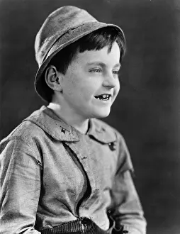 Tween: Portrait of a boy in a hat and grinning