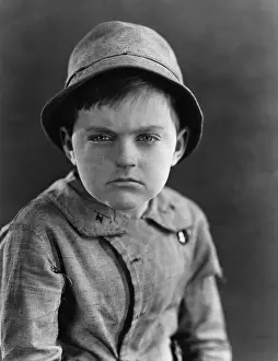 Displeasure: Portrait of a boy looking serious