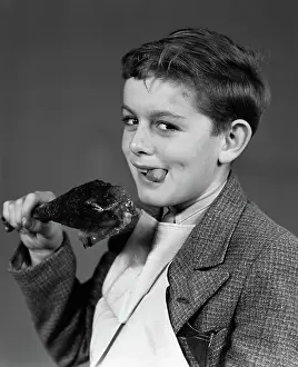 Freckle: Portrait of boy with napkin bib holding roast