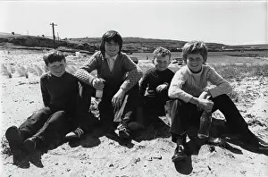 Aran: Portrait of four boys on a beach