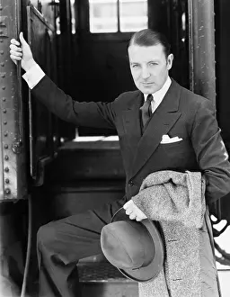 Fedora: Portrait of a businessman boarding a train