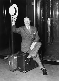 Headshots: Portrait of a businessman sitting on his suitcases