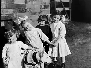 Playmate: Portrait of children outside with dog