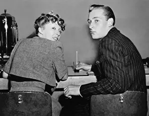 Foodstuff: Portrait of a couple sitting on a counter and looking