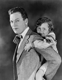 Paternal: Portrait of dad carrying son on his back