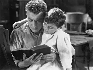 Involve: Portrait of dad reading bedtime story to son