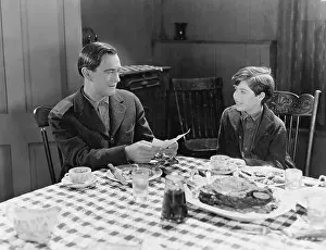 Paternal: Portrait of father and son at dinner table
