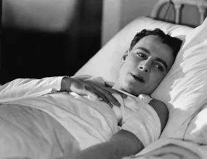 Fatigue: Portrait of injured man in bed
